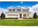 Two-story house with gray siding, stone accents, and a three-car garage at 437 Hammock Oaks Blvd, Lady Lake, FL 32159