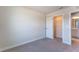 Neutral bedroom features a closet, carpet, and entry to an adjacent bathroom at 633 Highfalls Ave, Debary, FL 32713