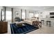 Open-concept living space featuring stylish furnishings, a cozy seating area, and adjacent breakfast bar at 1412 Laramie Way, Haines City, FL 33844