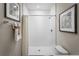 A minimalist, walk-in shower is well lit with neutral colors and modern hardware at 1412 Laramie Way, Haines City, FL 33844