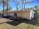 Home's backyard featuring an outdoor hot tub and a covered patio area at 1531 Ne 38Th St, Ocala, FL 34479
