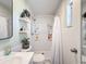 Bathroom featuring a sleek mirror, floating shelves and modern sink, complemented by a shower with white tiles at 1531 Ne 38Th St, Ocala, FL 34479