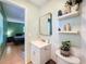 Bathroom featuring a sleek mirror, floating shelves and modern sink, complemented by tiled flooring at 1531 Ne 38Th St, Ocala, FL 34479