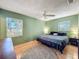 Well-lit bedroom with a ceiling fan and a comfortable bed with gray bedding and plush rug at 1531 Ne 38Th St, Ocala, FL 34479