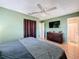 Bedroom with a sleek TV, dresser, and view of an en-suite bathroom, complete with tiled flooring at 1531 Ne 38Th St, Ocala, FL 34479