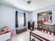 Bright bedroom featuring a window, dresser, and well-organized closet space, with tiled floor at 1531 Ne 38Th St, Ocala, FL 34479