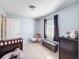 Bright bedroom with a window, tile flooring, and a comfortable, cozy layout at 1531 Ne 38Th St, Ocala, FL 34479