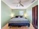 Comfortable bedroom featuring a ceiling fan, and tiled floor, complete with neutral green walls at 1531 Ne 38Th St, Ocala, FL 34479