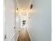 Hallway with wood-look floors leads to other rooms, providing a clear and connected path at 1531 Ne 38Th St, Ocala, FL 34479
