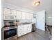 Clean kitchen with stainless steel appliances, granite countertops, and wood laminate flooring at 1531 Ne 38Th St, Ocala, FL 34479