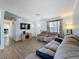 Comfortable living room featuring a large sectional sofa, tv and wood laminate flooring at 1531 Ne 38Th St, Ocala, FL 34479