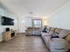 Inviting living room featuring modern wood floors and comfortable reclining seating at 1531 Ne 38Th St, Ocala, FL 34479
