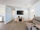 Comfortable living room featuring wood laminate flooring, large TV and a cozy sofa at 1531 Ne 38Th St, Ocala, FL 34479