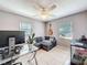 Comfortable office space with a corner couch, ceiling fan, and two large windows at 1531 Ne 38Th St, Ocala, FL 34479