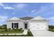 Charming single-story home with a well-manicured lawn and a two-car garage at 355 Biltmore Blvd, Dundee, FL 33838