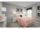 Cozy bedroom featuring pale pink ruffled bedding, two framed pictures, and modern lamps at 420 Harvard Ct, Dundee, FL 33838