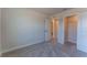 Bedroom with neutral walls and doors to an adjacent room and closet at 629 Highfalls Ave, Debary, FL 32713