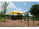 View of community playground featuring swings, slides, covered shade structure, and wood chip ground cover at 6919 Five Oaks Dr, Harmony, FL 34773