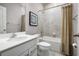 Cozy bathroom featuring neutral tones, tile wall and a shower-tub combination at 1624 Covey Rise Ter, Winter Haven, FL 33884