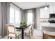 Kitchen and dining area featuring modern table setting near a large window, offering natural light at 1624 Covey Rise Ter, Winter Haven, FL 33884