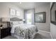 Serene bedroom with floral bedding, framed artwork, and bedside table with reading lamp at 1628 Covey Rise Ter, Winter Haven, FL 33884