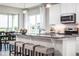 Kitchen with granite countertops, stainless appliances and island seating adjacent to the dining area at 1628 Covey Rise Ter, Winter Haven, FL 33884