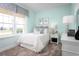 Bright and airy bedroom with a large window, soft blue walls, a comfortable bed, and stylish accents at 1632 Covey Rise Ter, Winter Haven, FL 33884