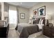 Cozy bedroom with a comfortable bed, stylish decor, a large window, and neutral colors at 1632 Covey Rise Ter, Winter Haven, FL 33884