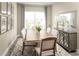 Elegant dining room with a large wooden table, seating for six, stylish decor, and plenty of natural light at 1632 Covey Rise Ter, Winter Haven, FL 33884