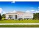Charming single-story home with a manicured lawn and a bright, inviting facade under a sunny blue sky at 1632 Covey Rise Ter, Winter Haven, FL 33884