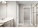 Bathroom featuring a shower with glass door, modern vanity, and access to the closet at 1636 Covey Rise Ter, Winter Haven, FL 33884