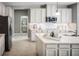 Modern kitchen featuring stainless steel appliances, white cabinets, and a view to bathroom at 1636 Covey Rise Ter, Winter Haven, FL 33884