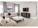 Comfortable living room with a modern entertainment center and neutral decor at 1636 Covey Rise Ter, Winter Haven, FL 33884