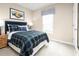 Comfortable bedroom with a plaid bedspread, a side table and a window at 2152 Tennessee St, Sumterville, FL 33585