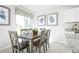 Charming dining area featuring a wooden table, decor, and natural light from a large window at 2152 Tennessee St, Sumterville, FL 33585