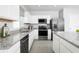 Bright kitchen with stainless steel appliances, granite countertops, and white cabinetry at 2152 Tennessee St, Sumterville, FL 33585