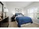 Cozy bedroom featuring a queen-size bed, a dresser, and a large window for natural light at 2183 Oklahoma Dr, Sumterville, FL 33585