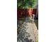 View of fenced backyard with stone path and central AC unit adjacent to the house at 600 Se 52Nd Ave, Ocala, FL 34471