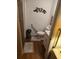 Cozy bathroom features a toilet with grab bar, vanity with storage, and decorative accents at 600 Se 52Nd Ave, Ocala, FL 34471