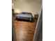 Bedroom features a bed with wood floors and a nightstand, showcasing a minimalist design at 600 Se 52Nd Ave, Ocala, FL 34471