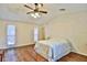 Spacious bedroom with wood floors, ceiling fan, and ample natural light from the windows at 600 Se 52Nd Ave, Ocala, FL 34471