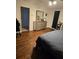 Bedroom with hardwood floors and a dresser, offering a tranquil and well-maintained interior space at 600 Se 52Nd Ave, Ocala, FL 34471