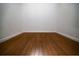 An empty room showcasing hardwood floors, white walls and white trim at 600 Se 52Nd Ave, Ocala, FL 34471