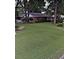 Charming brick home with well-maintained front yard, lush landscaping, and mature trees at 600 Se 52Nd Ave, Ocala, FL 34471