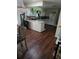 Cozy kitchen with white cabinets, an island with granite counters and dark hardwood floors at 600 Se 52Nd Ave, Ocala, FL 34471