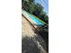Inviting swimming pool with deck chairs and lush landscaping at 600 Se 52Nd Ave, Ocala, FL 34471