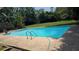 Exterior view of the sparkling backyard pool with a spacious surrounding deck at 600 Se 52Nd Ave, Ocala, FL 34471