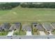 Aerial view of the home showcasing its proximity to an expansive grassy field and neighboring residences at 9773 Sw 63Rd Loop, Ocala, FL 34481