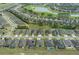 High aerial view of a neighborhood showcasing numerous homes near a golf course and tranquil pond at 9773 Sw 63Rd Loop, Ocala, FL 34481