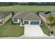 Aerial view of a beautiful single-Gathering home with a lush green lawn and a spacious two-car garage at 9773 Sw 63Rd Loop, Ocala, FL 34481